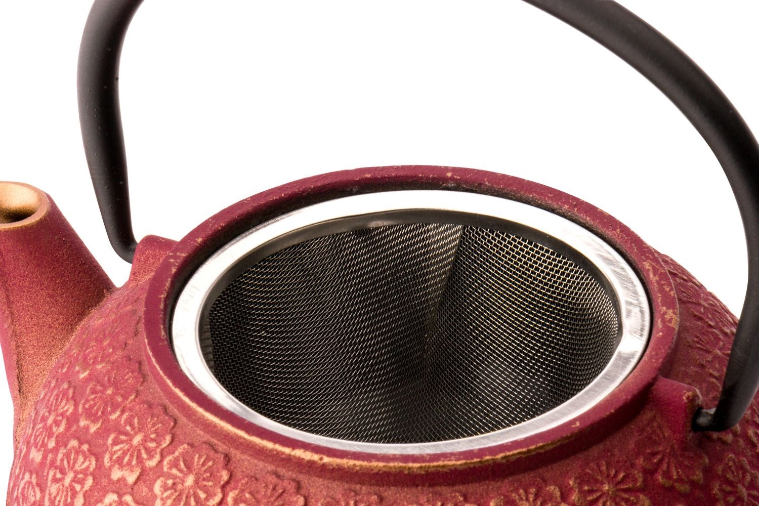 Close-up of red teapot with metal infuser
