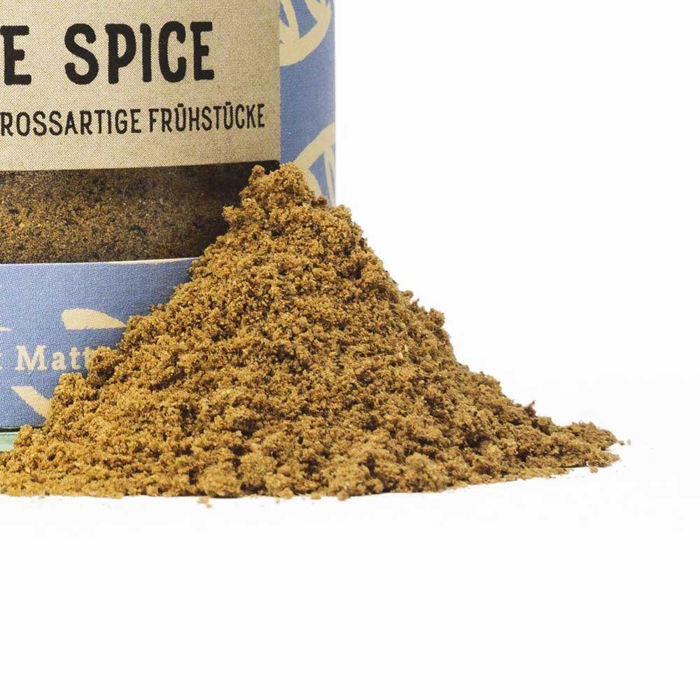 Powdered pumpkin spice seasoning piled in front of an open tin, perfect for refining breakfast dishes