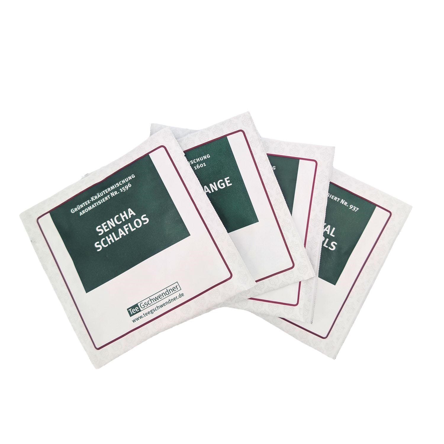 Several individually wrapped Tee Gschwendner tea bags, including Sencha Schlaflos, fanned out on a white background