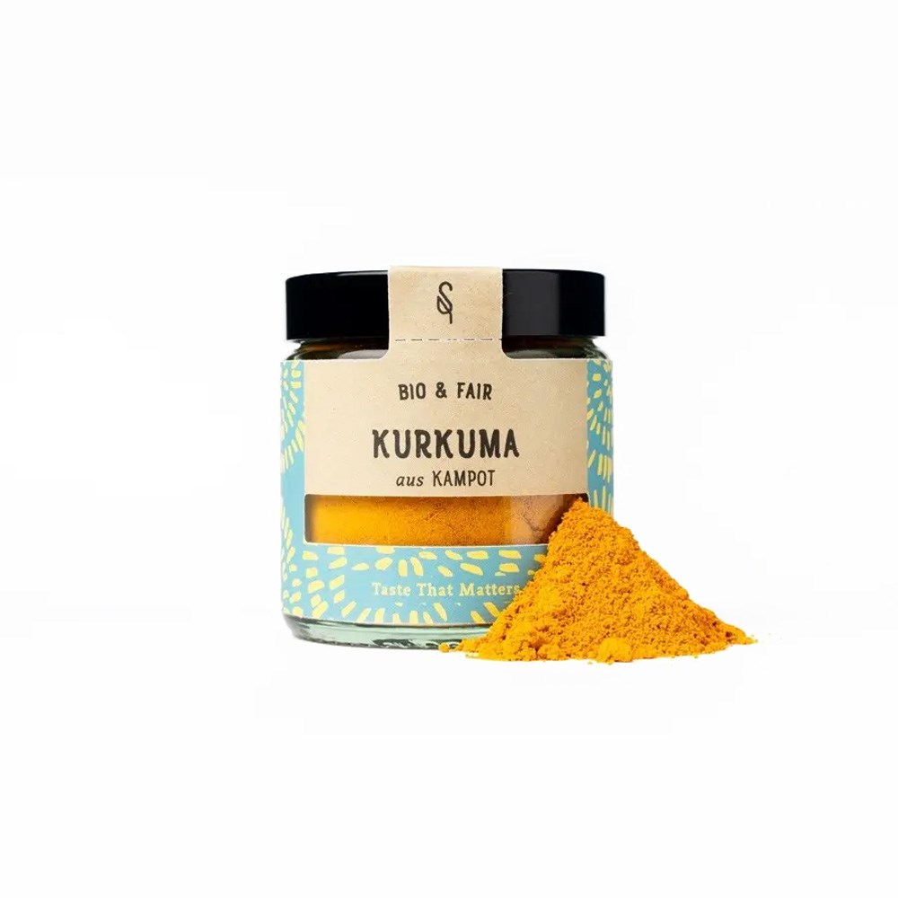 Bocal de curcuma bio & équitable de Kampot avec un petit tas de poudre de curcuma jaune vif à côté