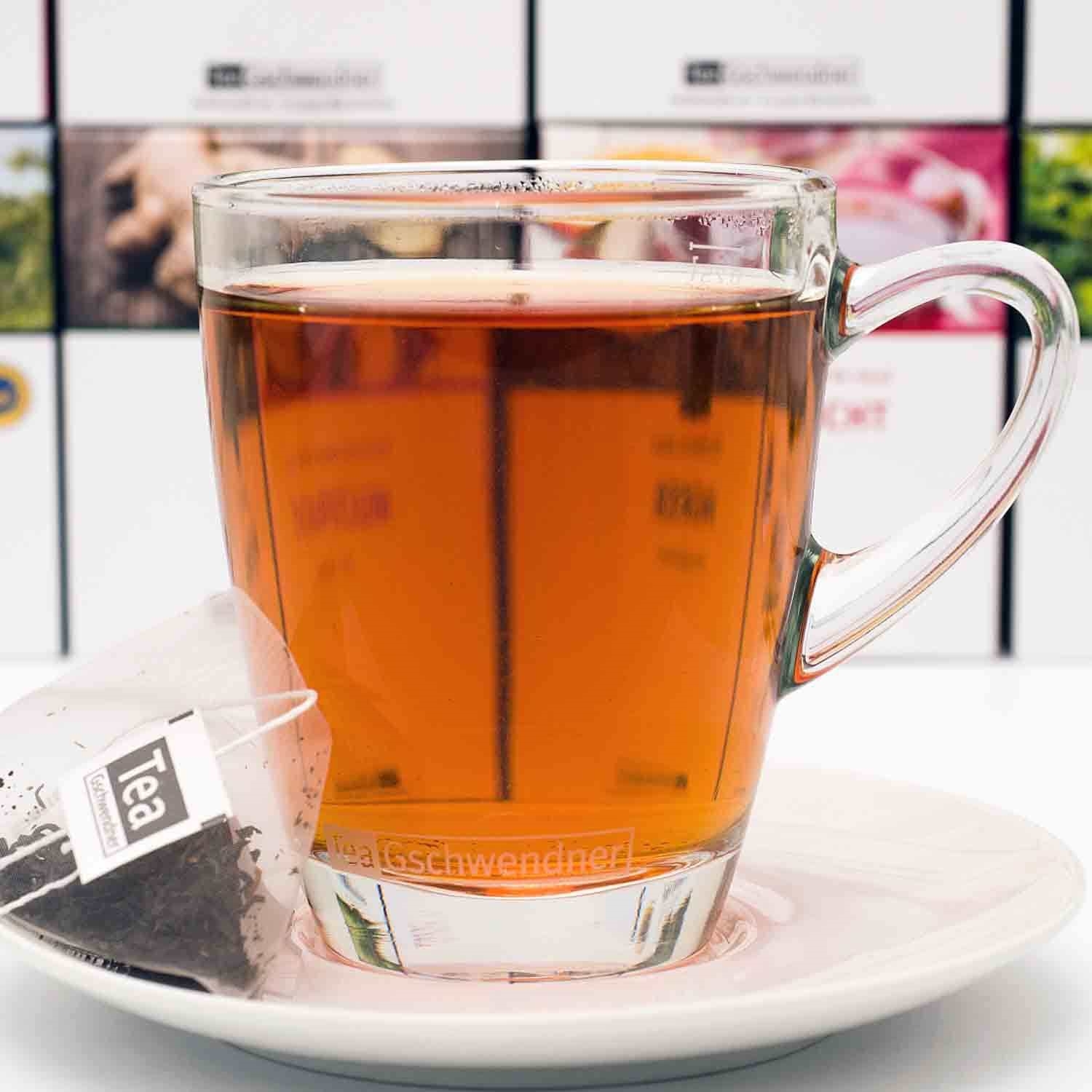 Heißer Tee im Glas mit Teebeutel auf Untertasse, Glas, Tee, Teebeutel, Kanne, Becher