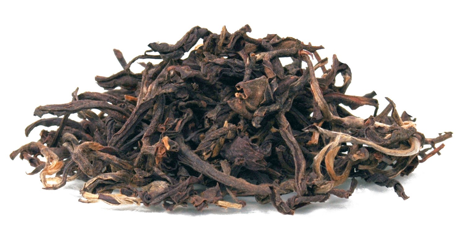Dried loose black tea leaves on white background