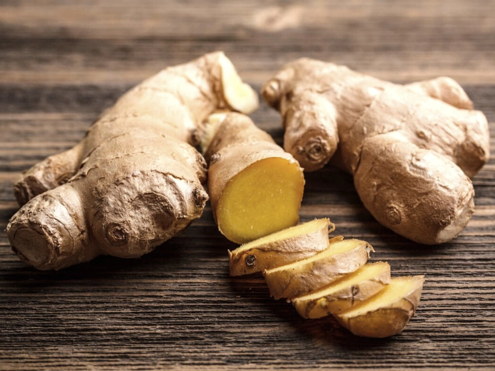 Fresh ginger root, cut and sliced