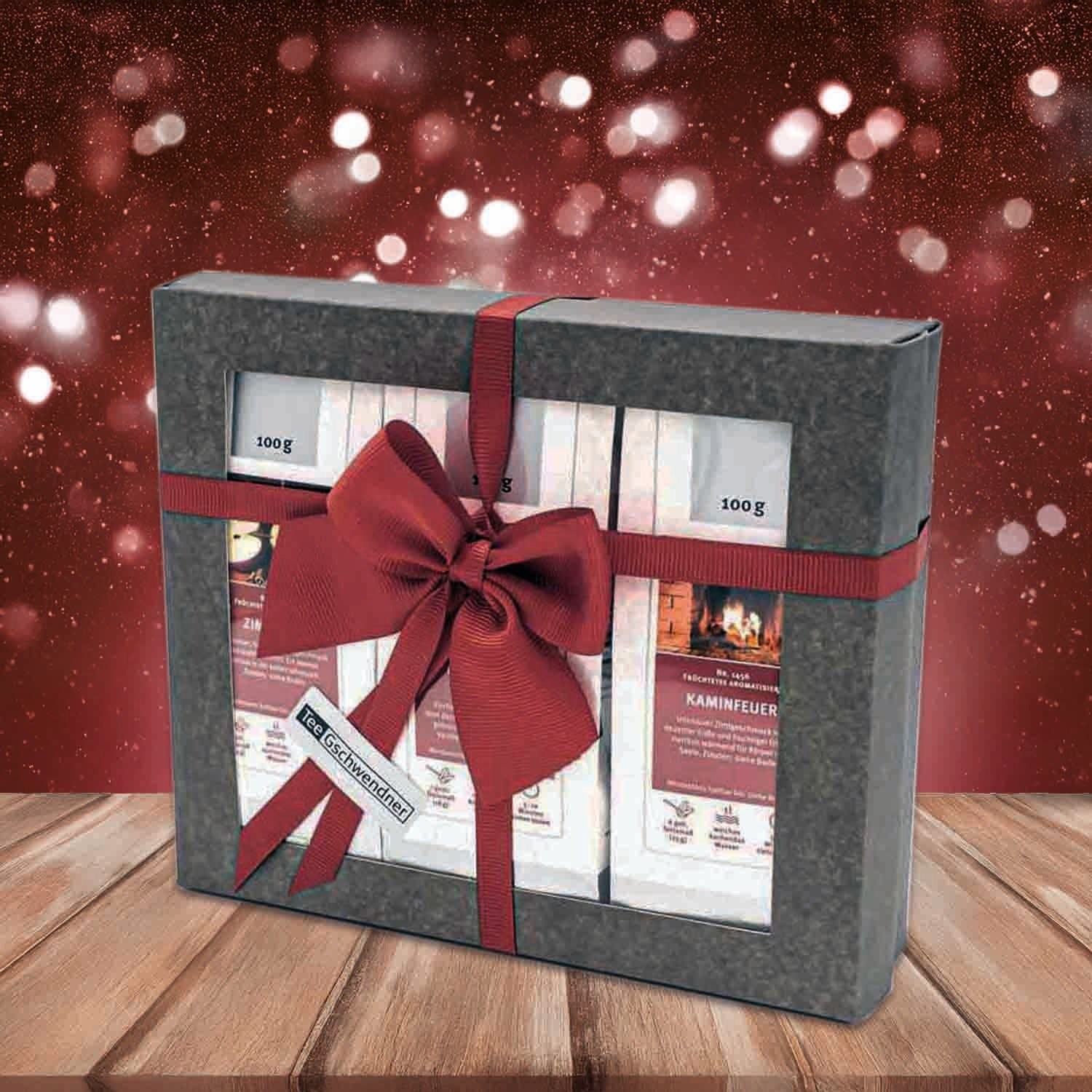 Festive tea gift set with bow against sparkling background