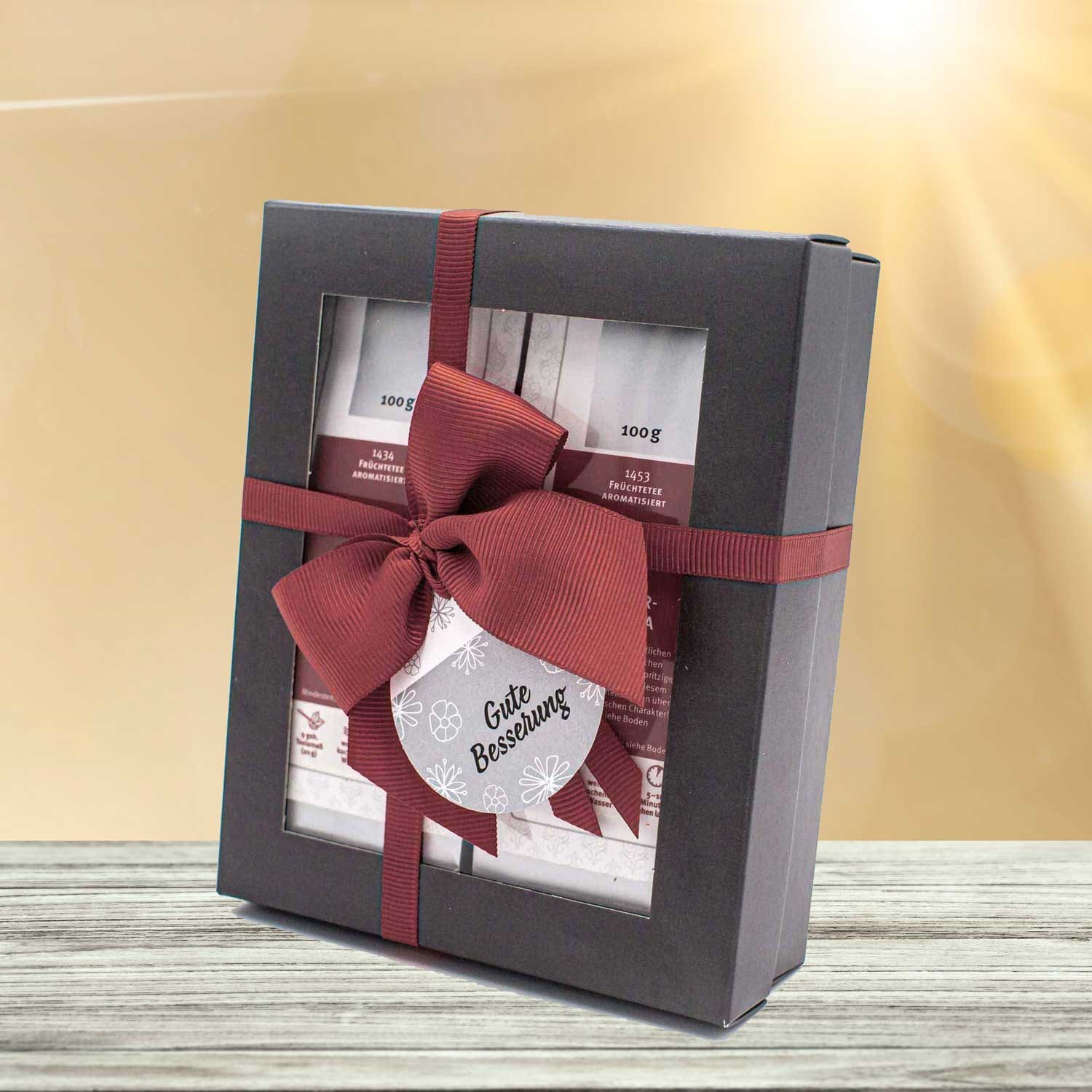 Schwarzes Tee-Geschenkset mit roter Schleife Gute Besserung, Geschenkset, Schachtel, Rote Schleife, Verpackung, Geschenkbox
