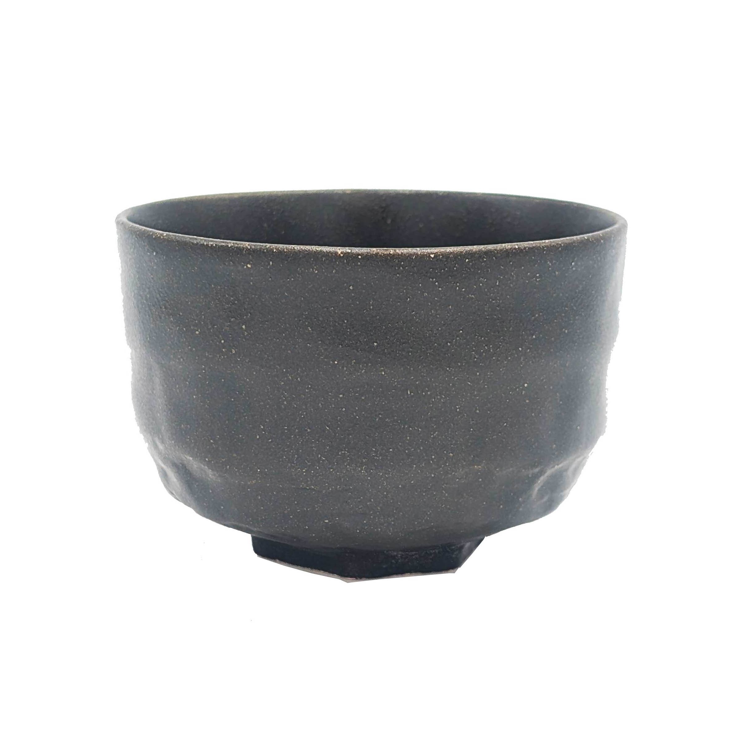 Black ceramic tea bowl with rough surface