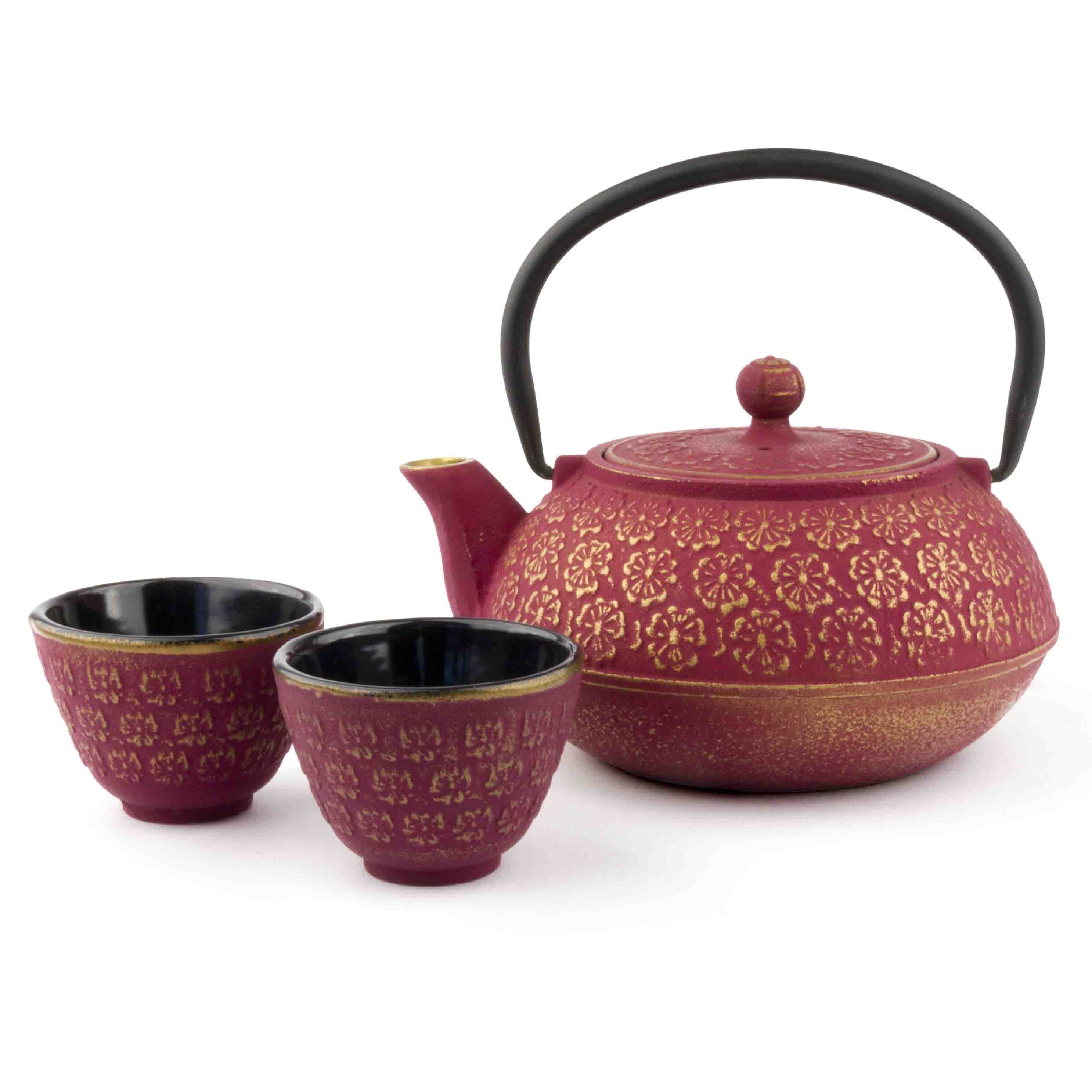 Red cast iron teapot with two matching cups