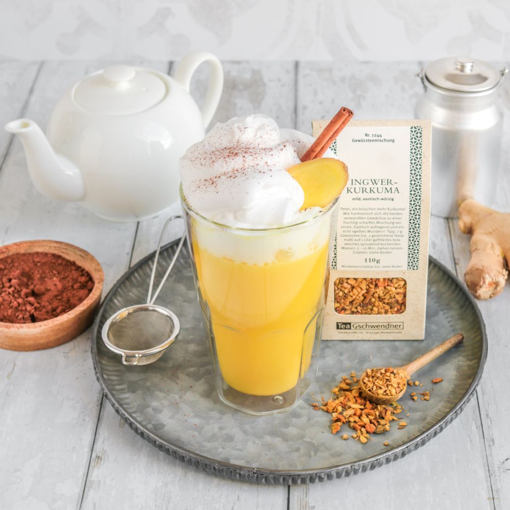 Glass of ginger turmeric latte with foam top