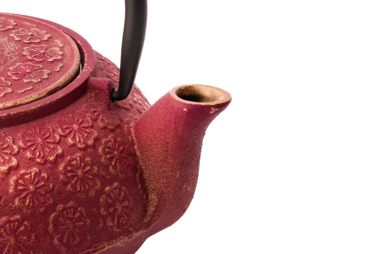 Red cast iron teapot with flower decorations