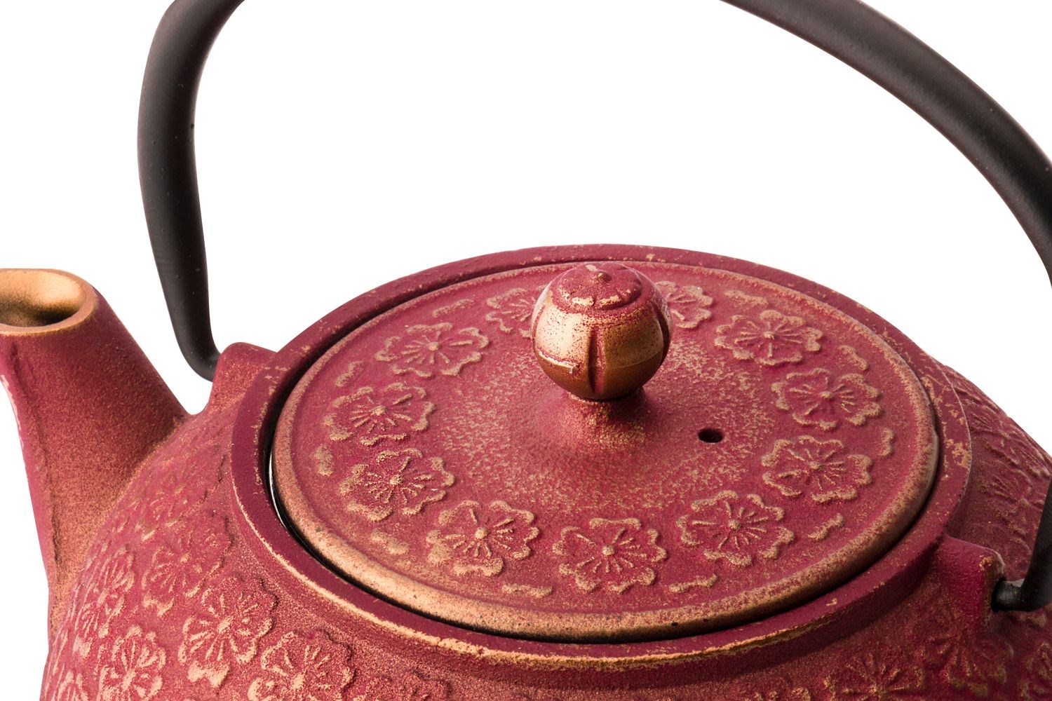 Red cast iron teapot with floral pattern