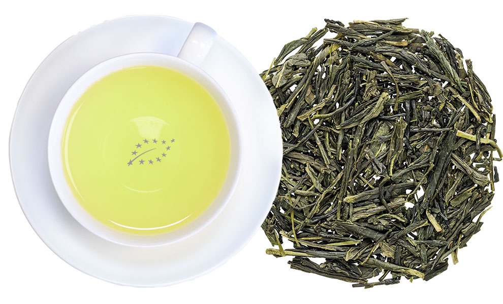Tasse grüner Tee neben losen grünen Teeblättern, grüner tee, loser tee/blätter, tee tasse, gelb tee, zeremoniell
