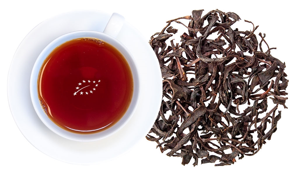 Tasse Schwarzer Tee neben losen Teeblättern, Kirschtopf-Tee, Schwarztee, Tee-Teeblatt, Kreis-Tee, Rotes Tee-Getränk