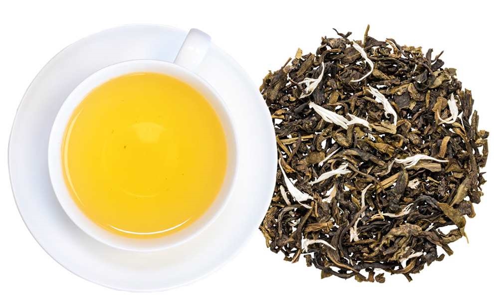 Weiße Tasse mit grünem Tee und losen Teeblättern, tee, grüner tee, tee-blätter, tee-aufguss, honiggelb