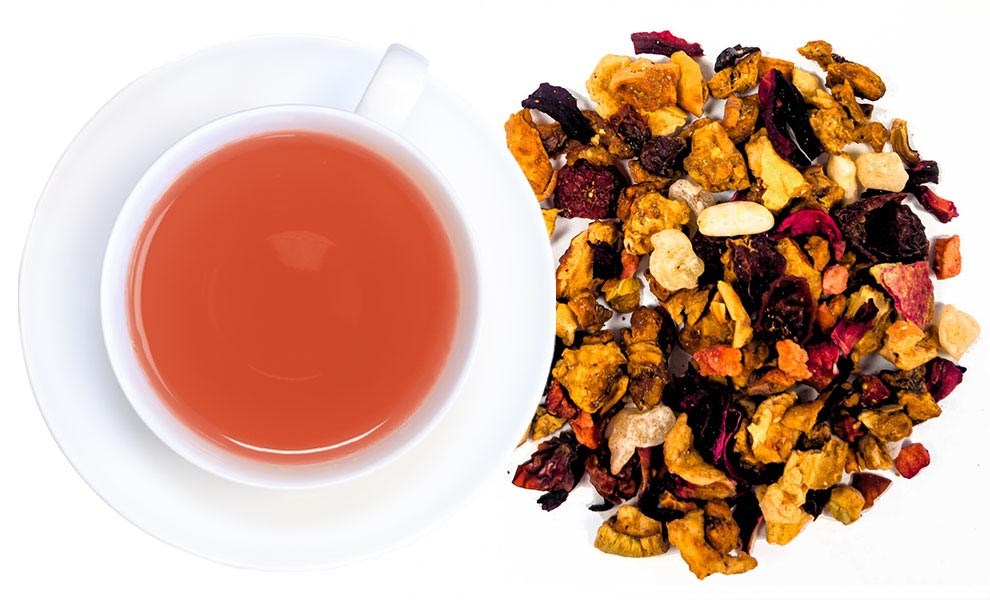 White cup of red fruit tea and dried fruit mix