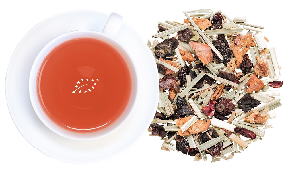 Weiße Tasse mit rotem Früchtetee und losem Lemongras-Tee