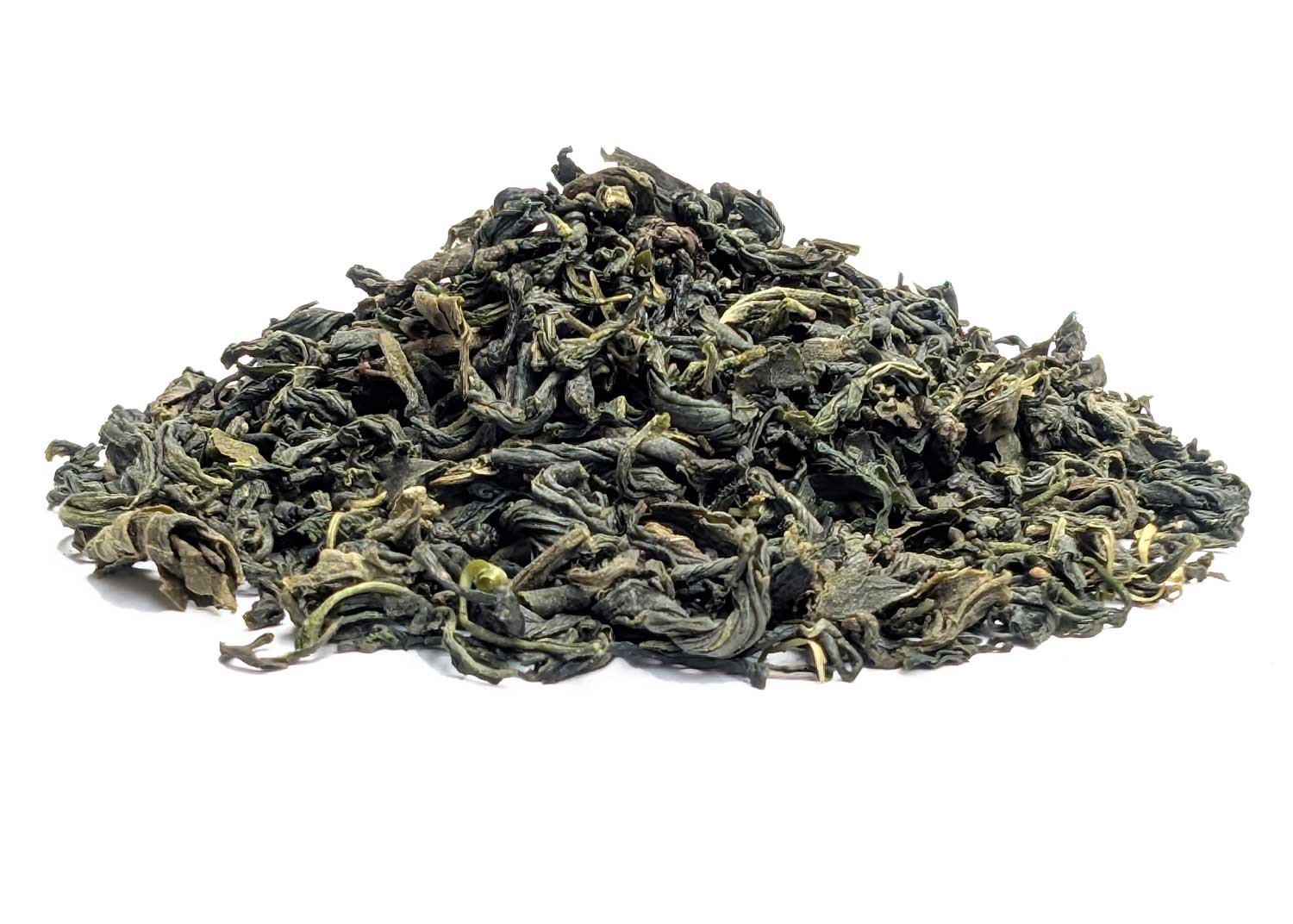 Pile of loose green tea leaves in premium leaf quality on white background