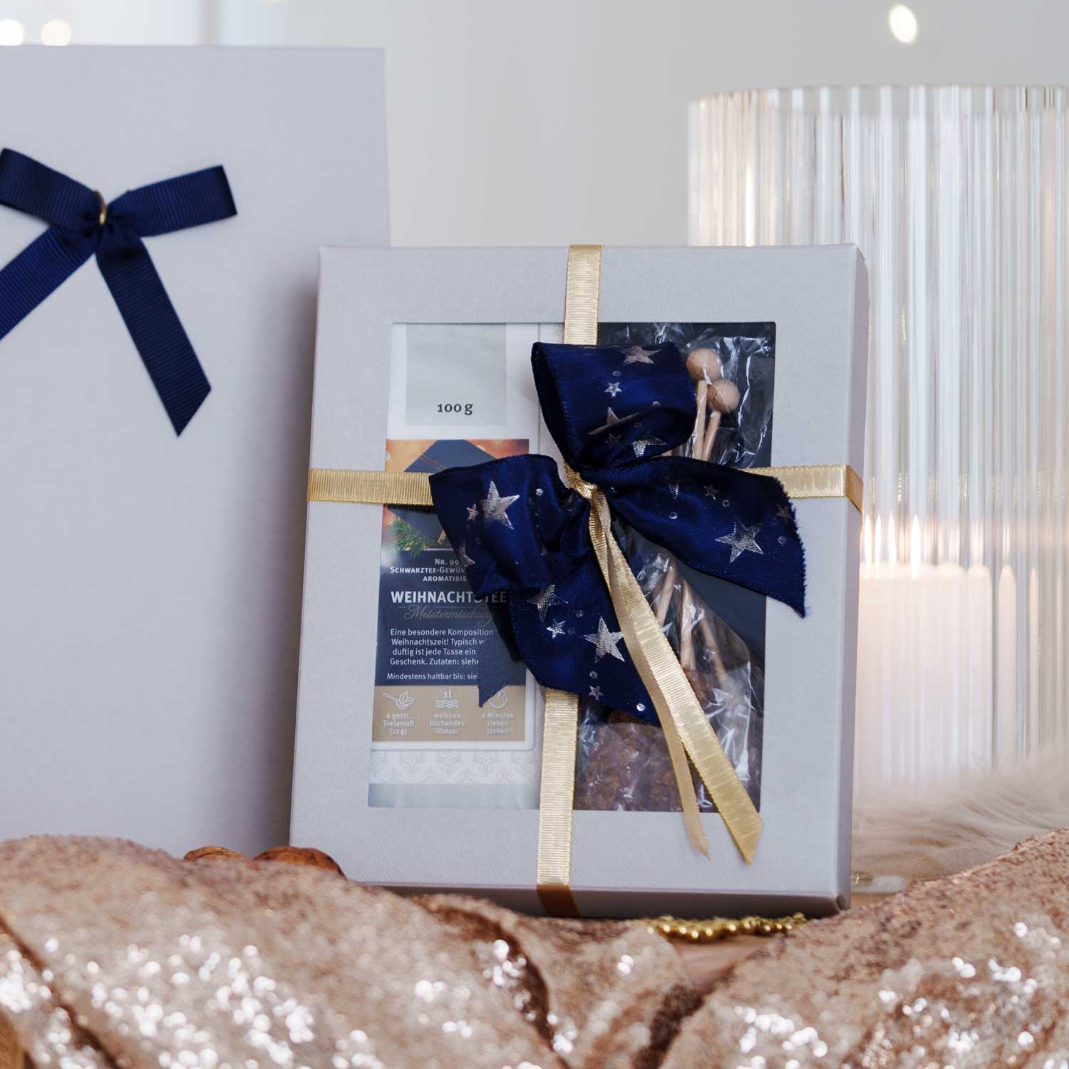 Gift box with Christmas tea and sugar sticks neatly wrapped