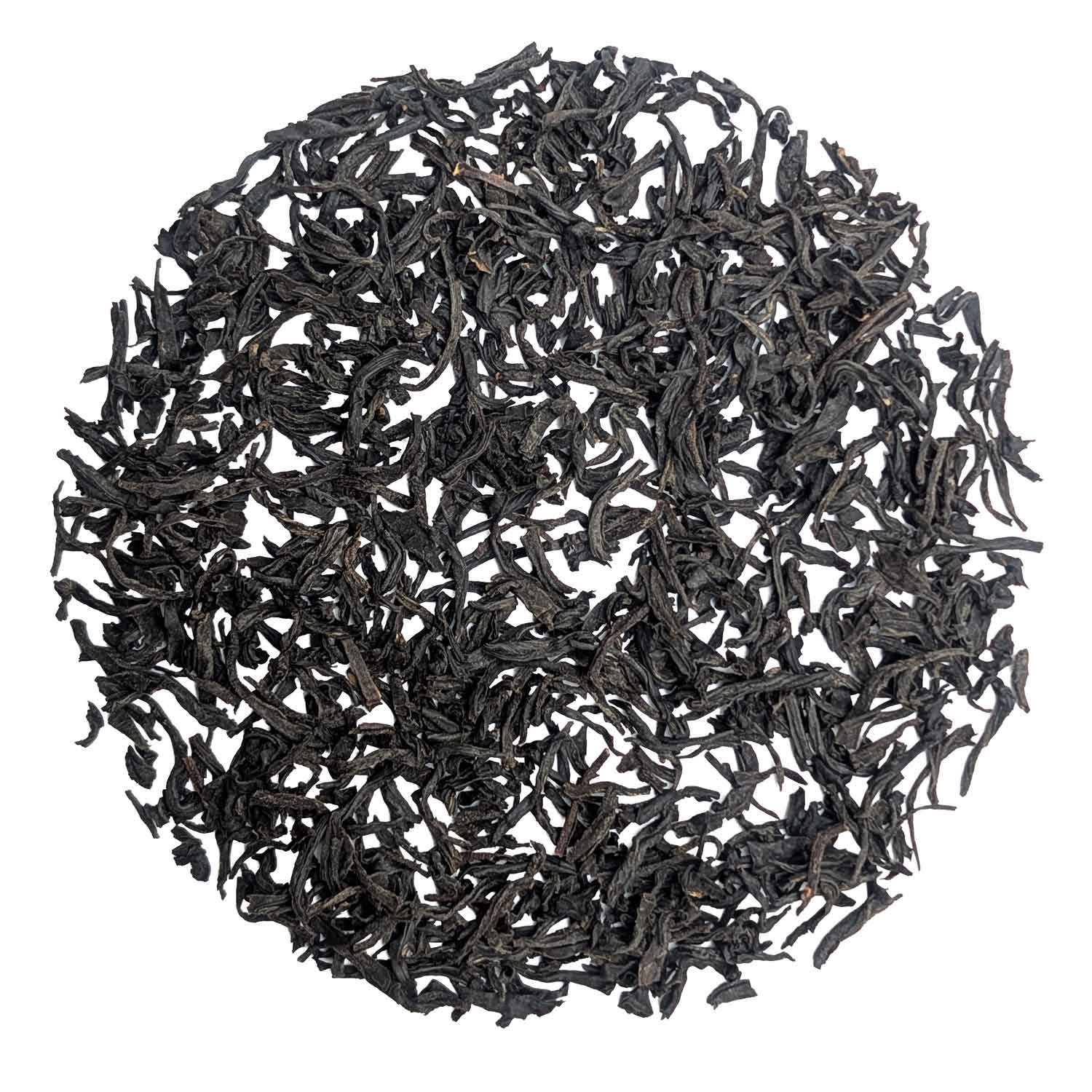 Close-up of loose black tea leaves as a product image on a white background